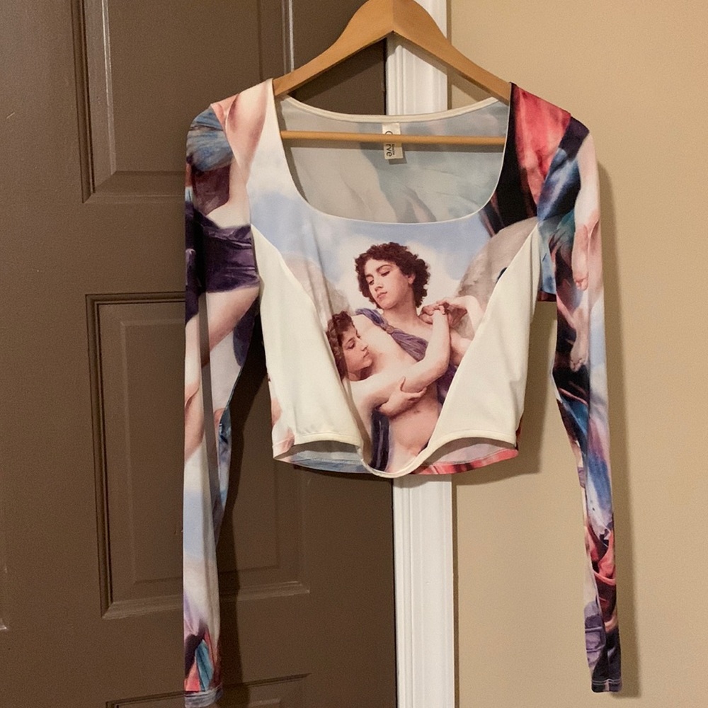 This is from Kimcine Curve . It is an Angelic long sleeve belly shirt!!